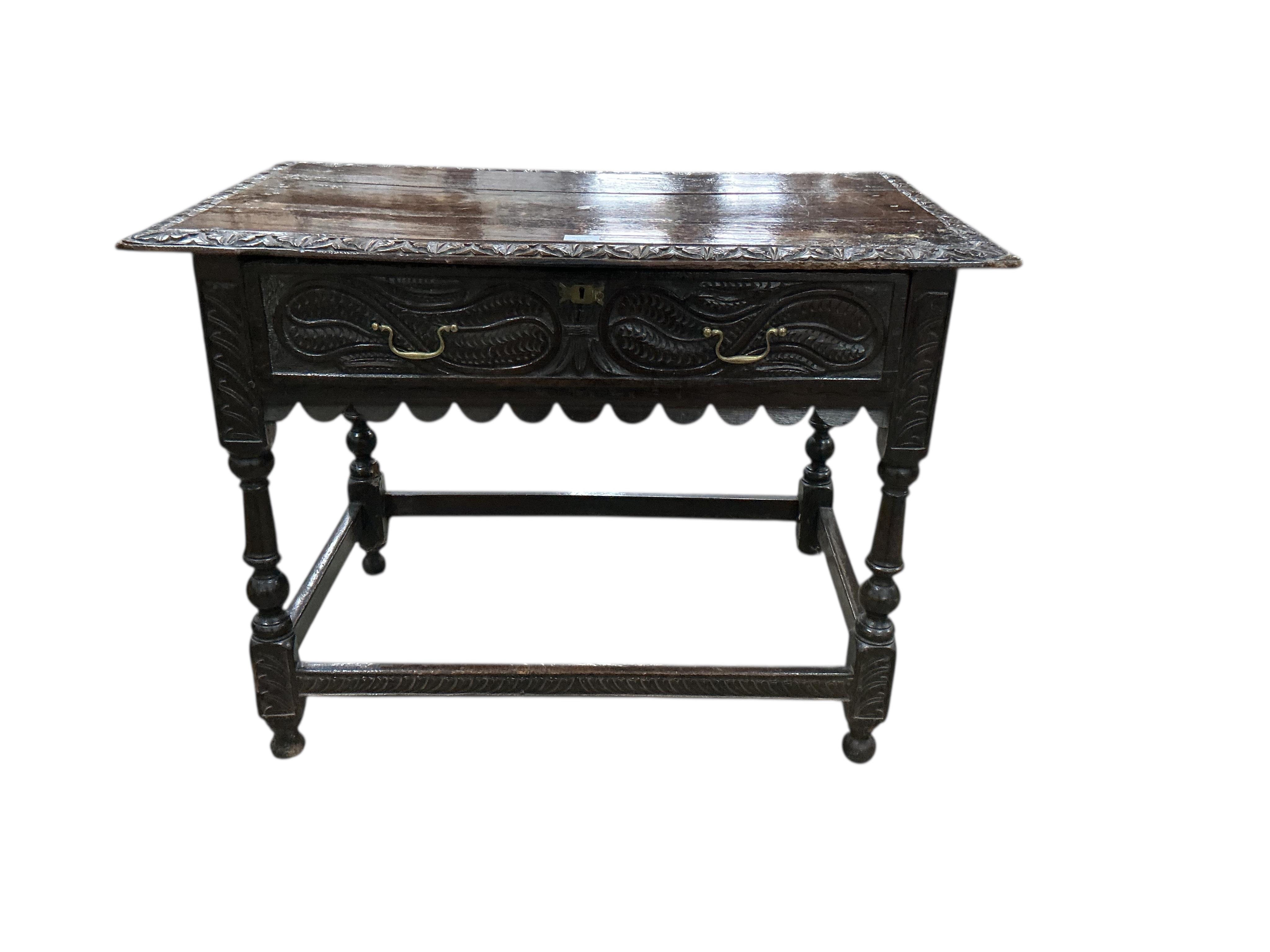 An early 18th century oak side table, later carved, width 99cm, depth 60cm, height 74cm